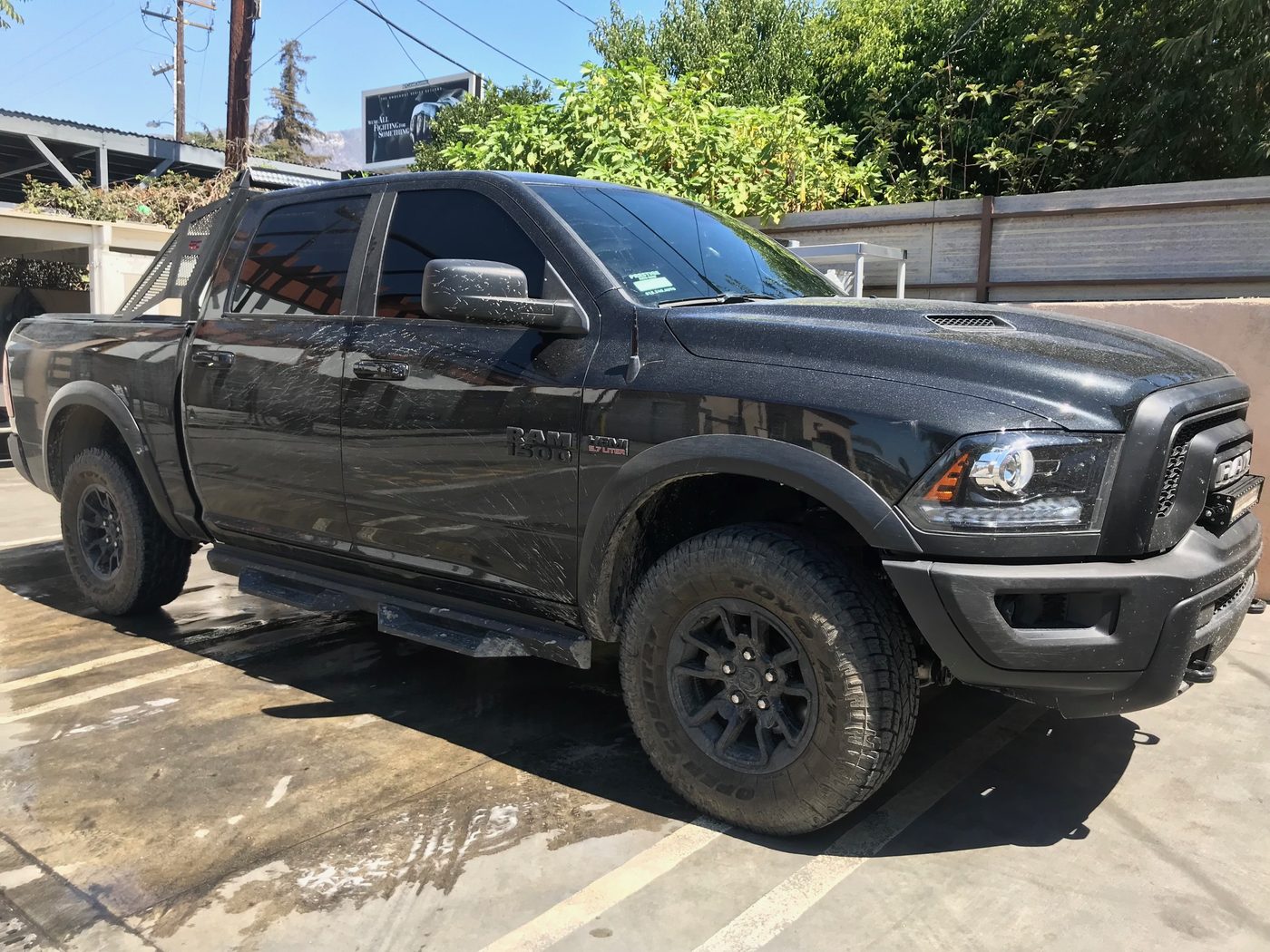 Black Ram 1500 truck mid-wash with foam and water at Fair Oaks Car Wash