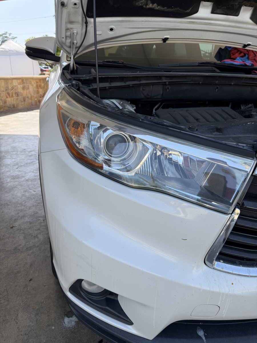 Same Toyota Highlander headlight after restoration showing crystal-clear plastic at Fair Oaks Car Wash